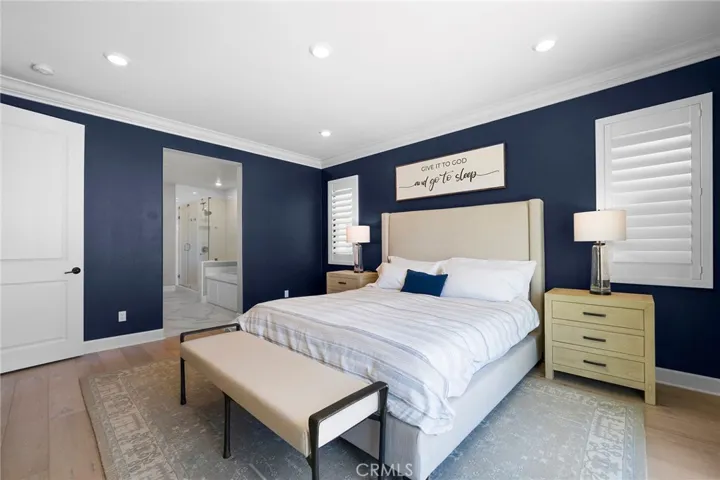 Primary suite with shutters, blackout shades, designer drapes (shown with King bed)