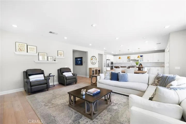 The spacious great room is open to dining and kitchen