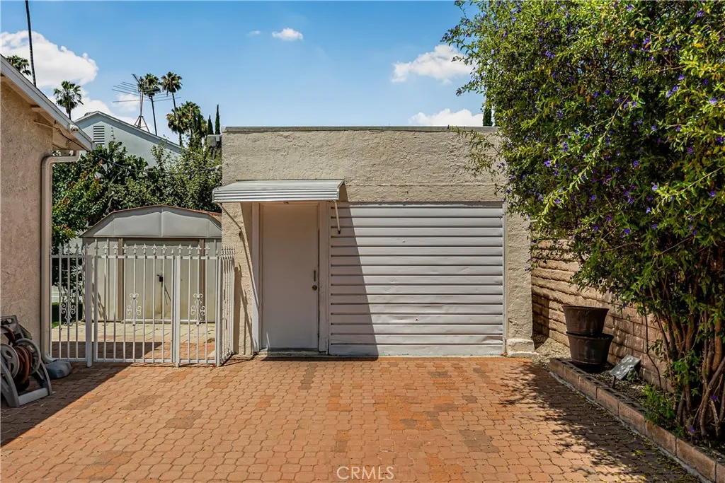 ONE CAR GARAGE, CURRENTLY UTILIZED AS STORAGE AND LAUNDRY ROOM