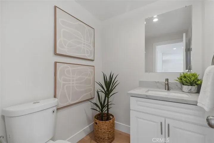 Downstairs guest bathroom with new shaker cabinetry and quartz countertop~