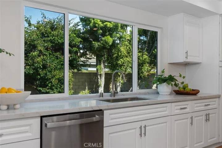 Brand new expansive dual pane kitchen windows overlooking the relaxing backyard...