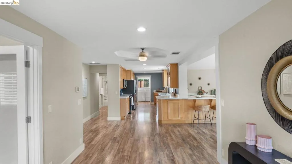 Wood-finish flooring extending throughout the open-concept interior