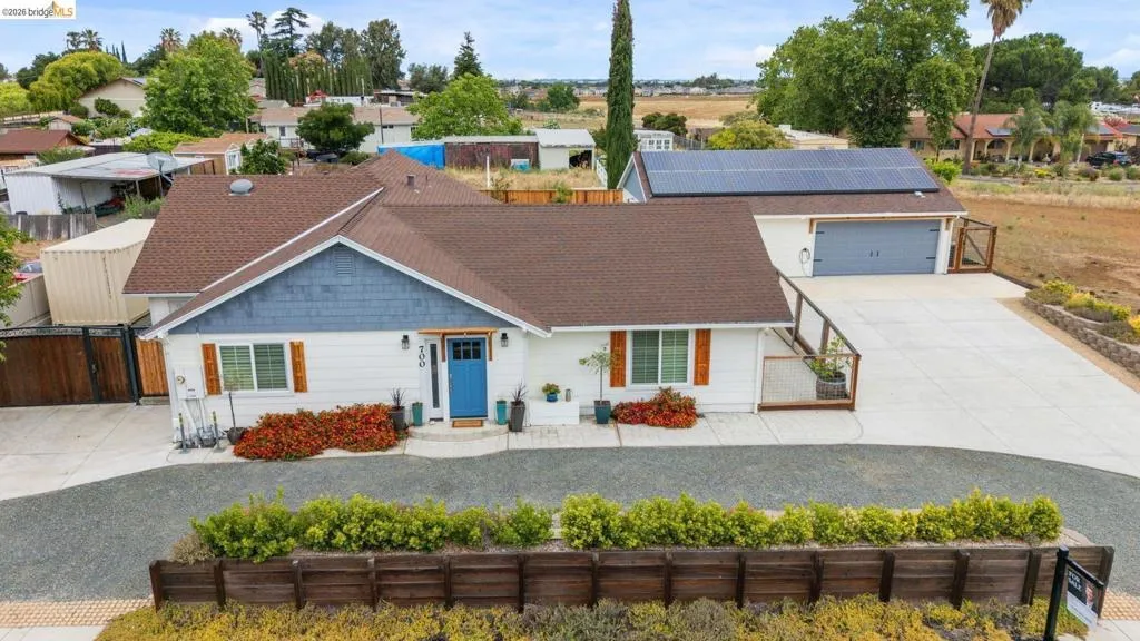 White exterior with blue siding accent and dark brown roof