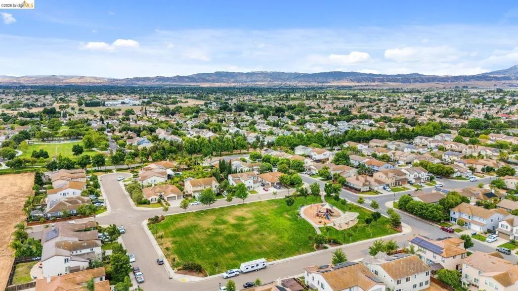 Aerial perspective showcasing a residential neighborhood with a central green space