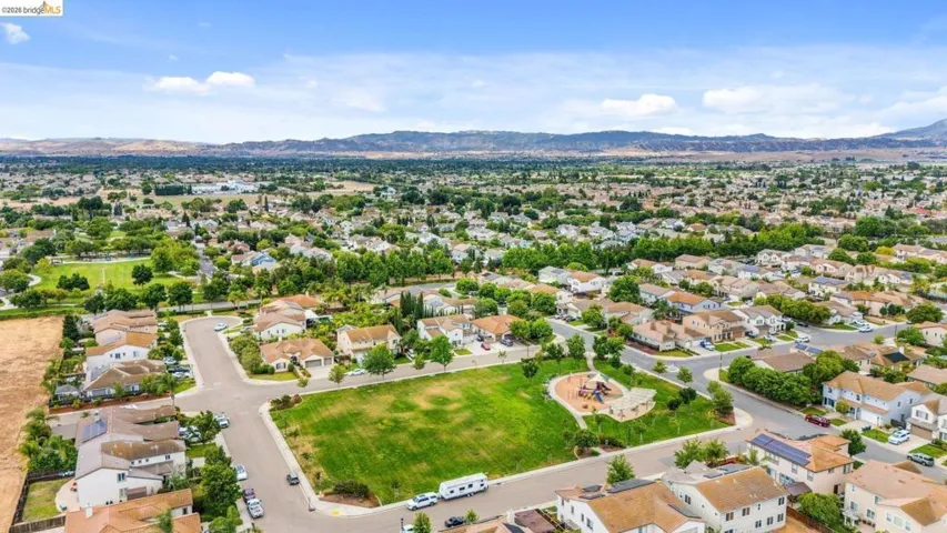 Aerial perspective showcasing a residential neighborhood with a central green space
