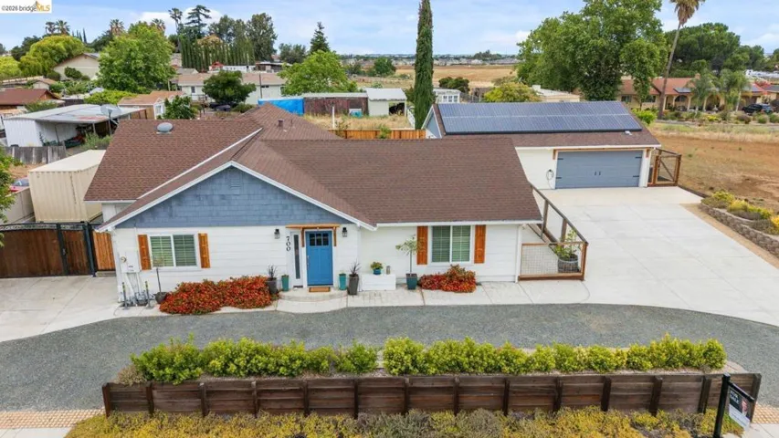 White exterior with blue siding accent and dark brown roof