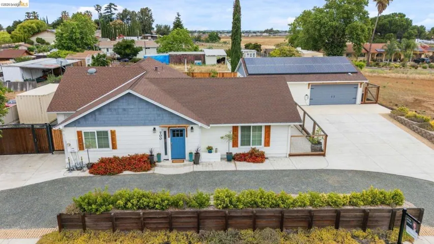 White exterior with blue siding accent and dark brown roof