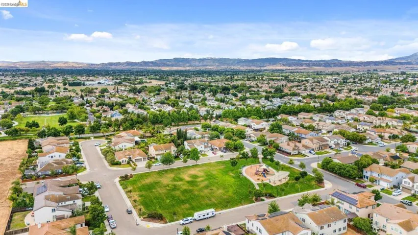 Aerial perspective showcasing a residential neighborhood with a central green space