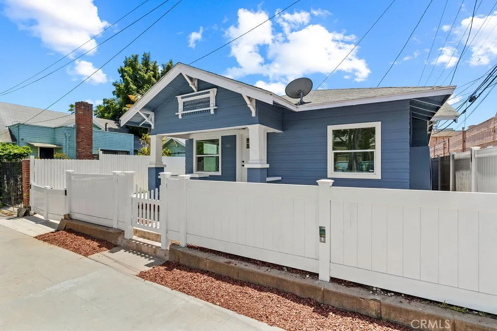 Charming Craftsman elevation with updated exterior finishes and gated front entry.