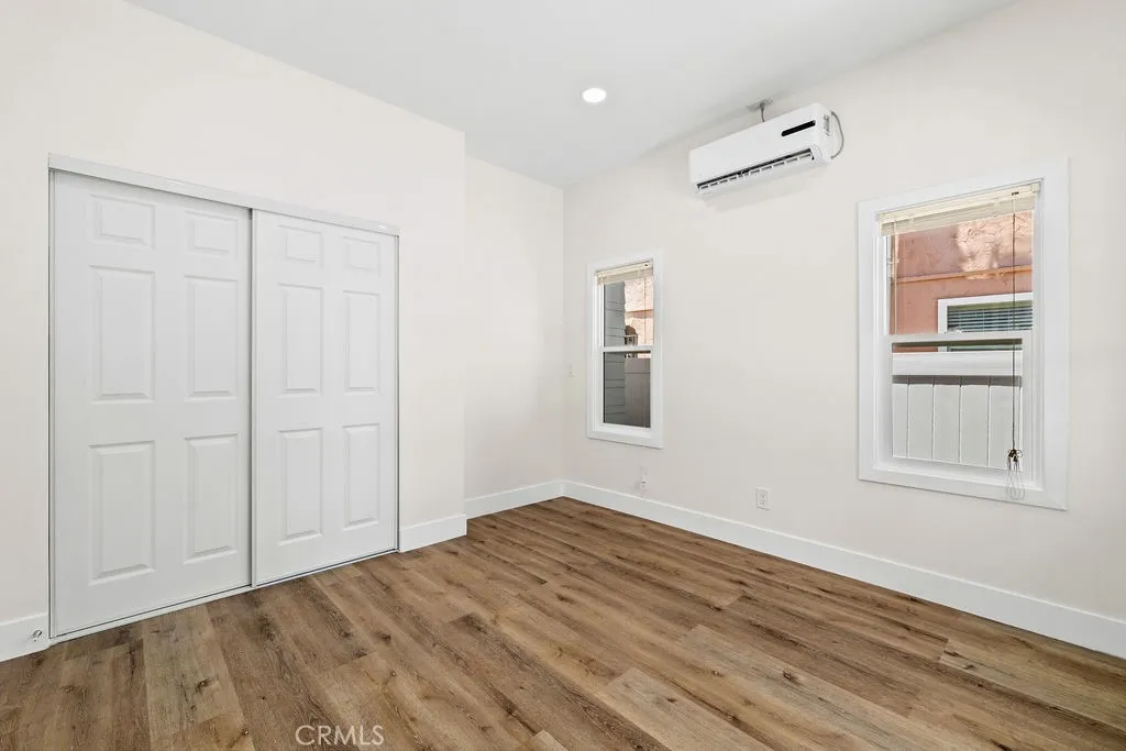 Bedroom with updated closet doors, modern finishes, and abundant natural light.