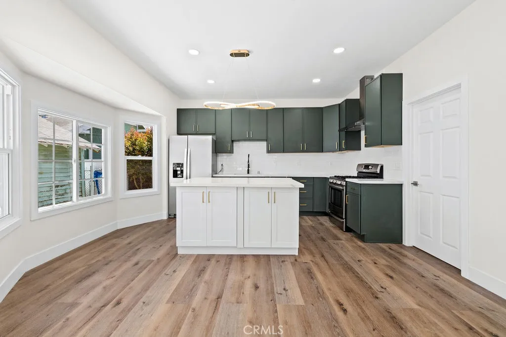 Expansive open-concept floor plan with wide-plank flooring and abundant natural light throughout.