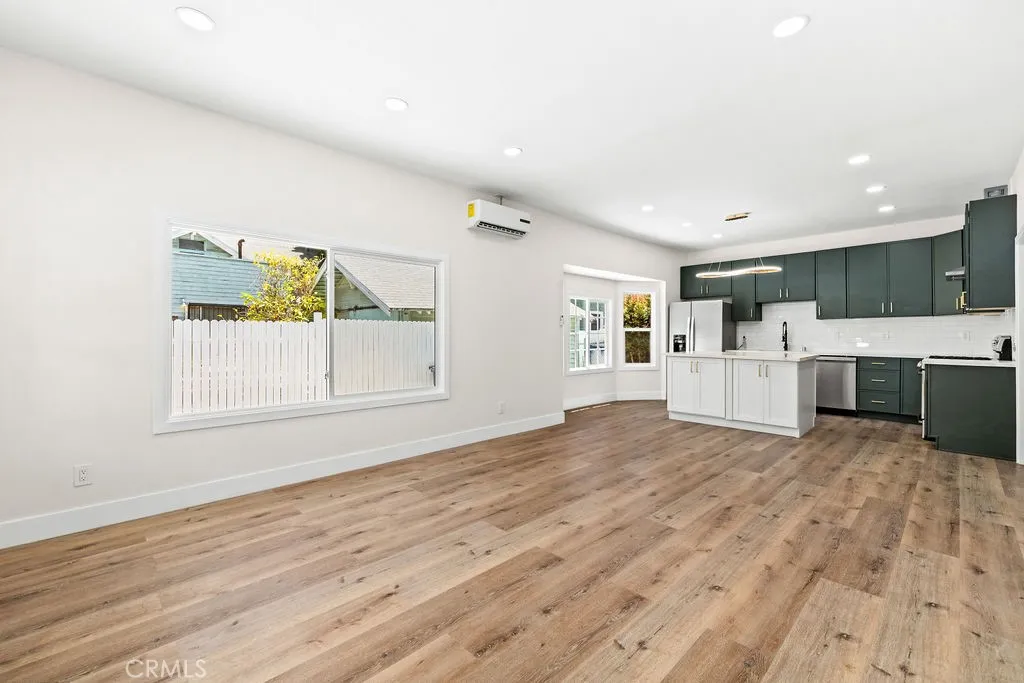Spacious family room and kitchen combination with modern finishes and recessed lighting throughout.