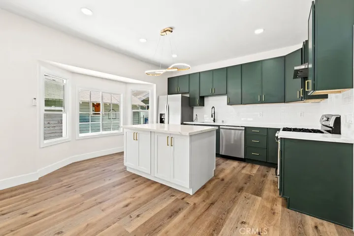Spacious kitchen and dining area with oversized island seating and abundant natural light.