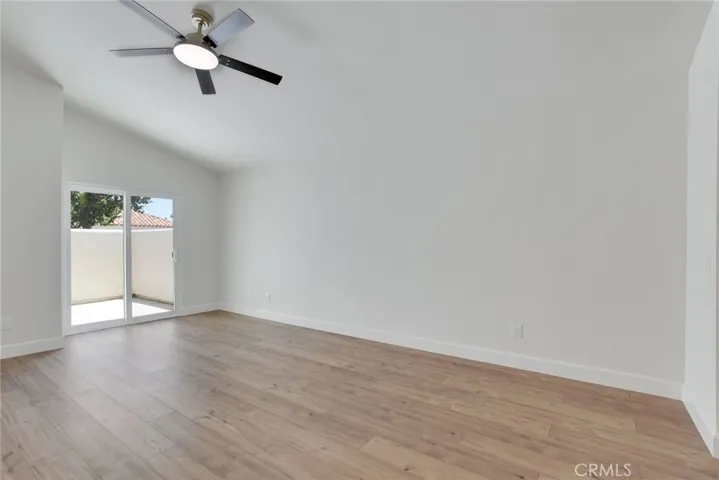 Large primary bedroom with vaulted cieling and private patio