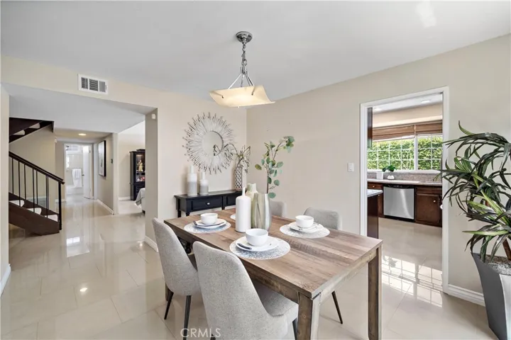 The home also features a separate formal dining room and an inviting family room with a wet bar that opens to the upgraded kitchen