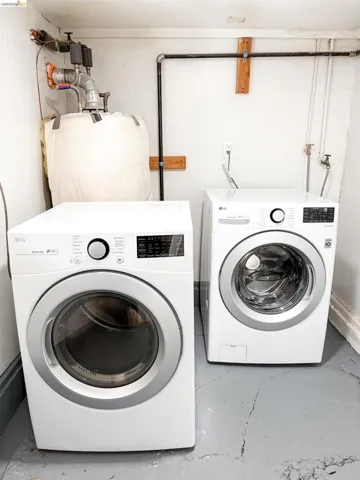Dedicated laundry area featuring a white front-loading washer and dryer set