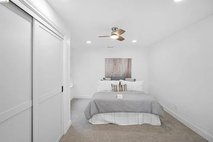 Bright room featuring recessed lighting and a ceiling fan with integrated lighting