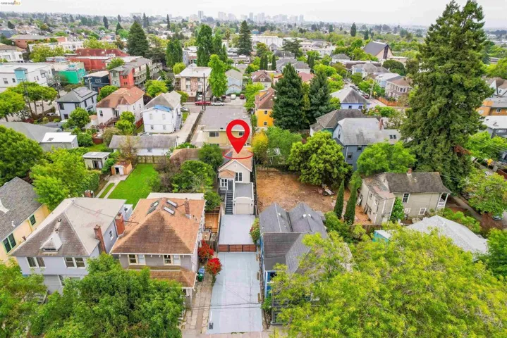 Aerial perspective showcasing the property with a two-story structure, covered entry, and external staircase