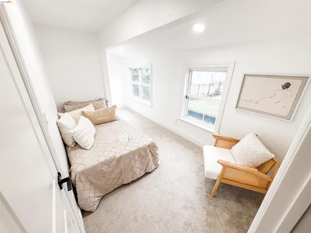 Bright interior space featuring two windows, recessed lighting, white trim, and light-colored carpeting