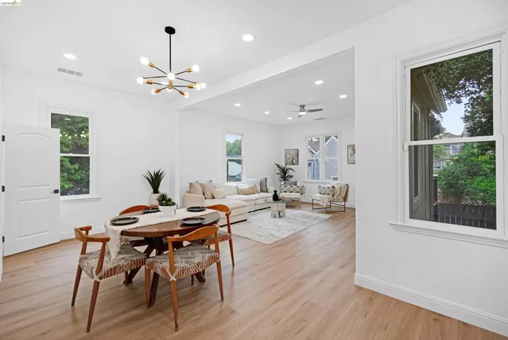 Open-concept living space featuring wood-finish flooring, recessed lighting, and white trim throughout