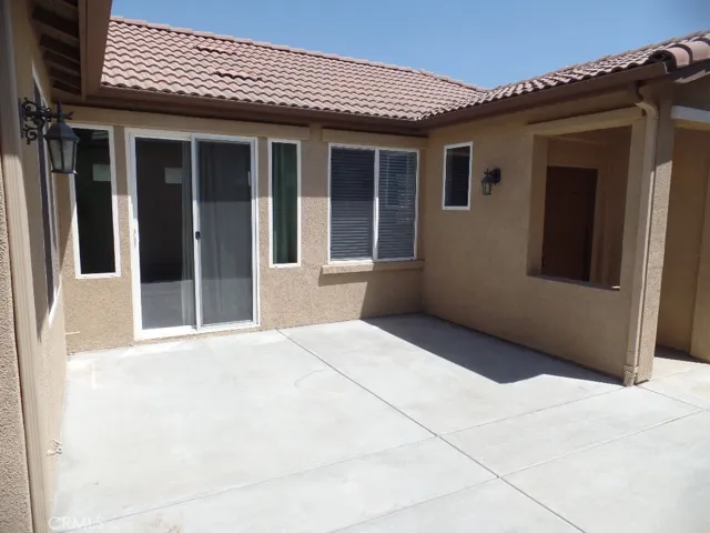 Side patio with front door and sliding door