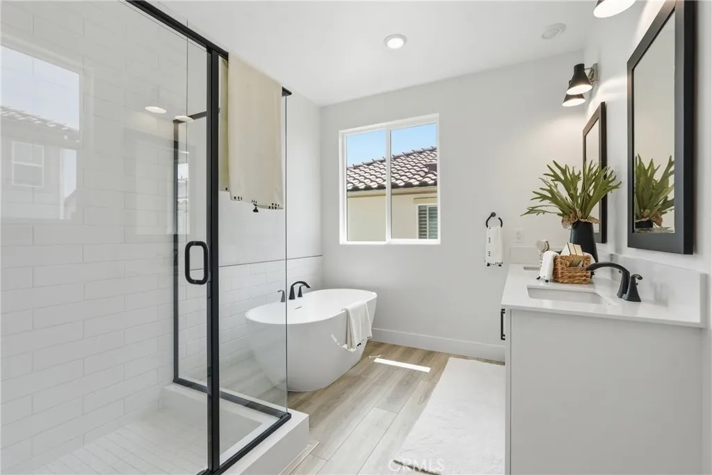Spa-inspired bathroom featuring a freestanding soaking tub, oversized shower, and dual-sink vanity.