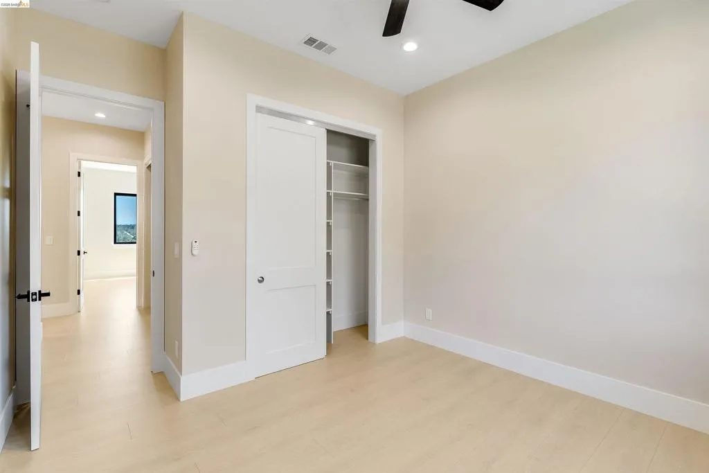 Light wood-finish flooring complements neutral wall tones and white baseboards