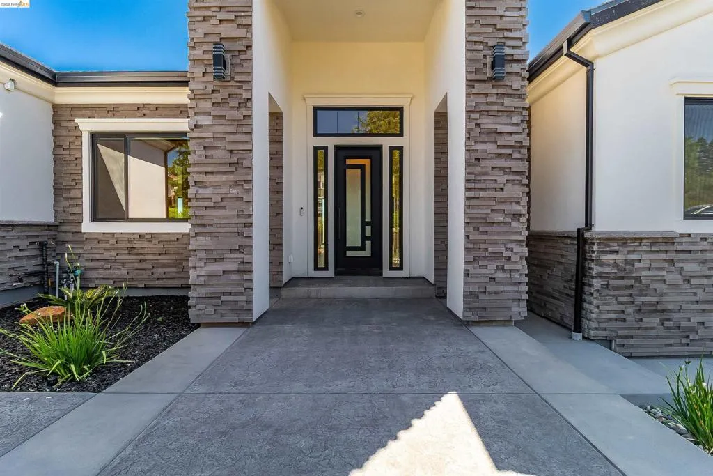 Contemporary exterior featuring stacked stone accents and smooth stucco