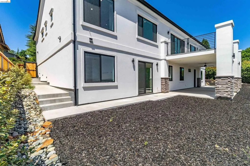 Modern architecture with a white stucco finish and contrasting black-framed windows
