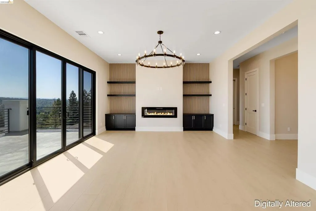Spacious interior with light wood-finish flooring and a contemporary linear fireplace