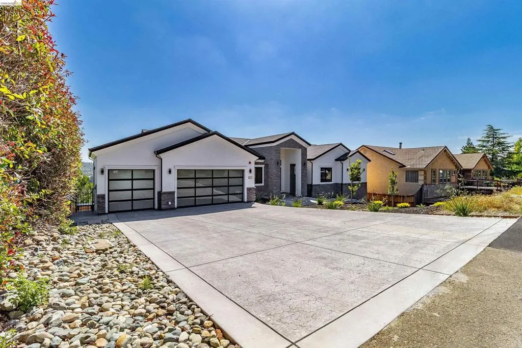 Contemporary exterior with white stucco and stone accents
