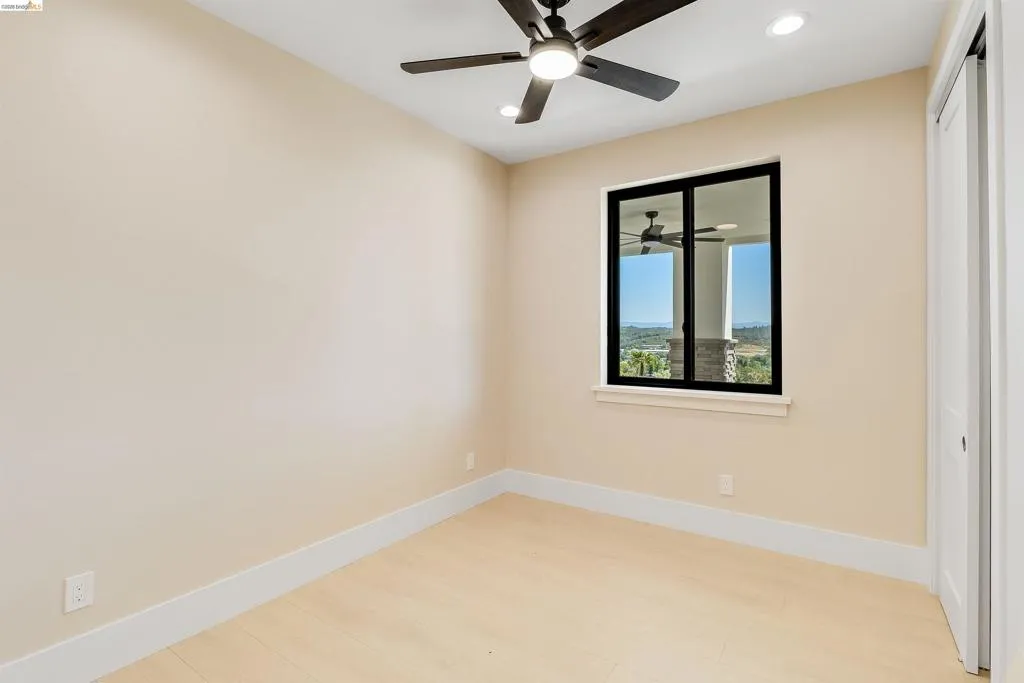 Neutral wall tones complement the light wood-finish flooring