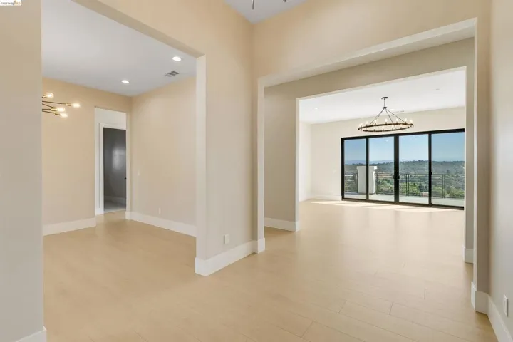 Open-concept interior featuring light wood-finish flooring and neutral-toned walls