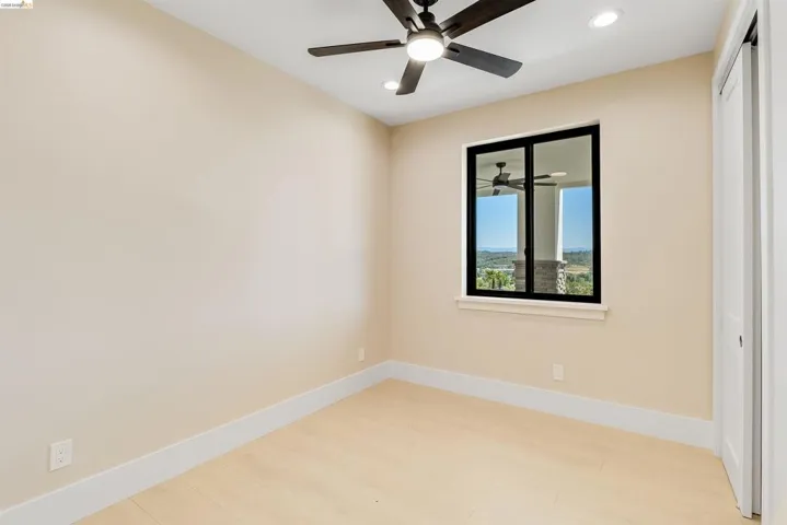 Neutral wall tones complement the light wood-finish flooring