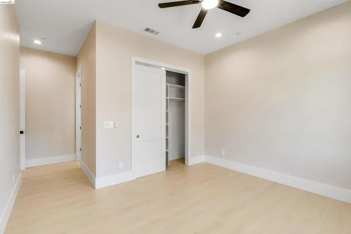 Room featuring light wood-finish flooring, recessed lighting, and a ceiling fan