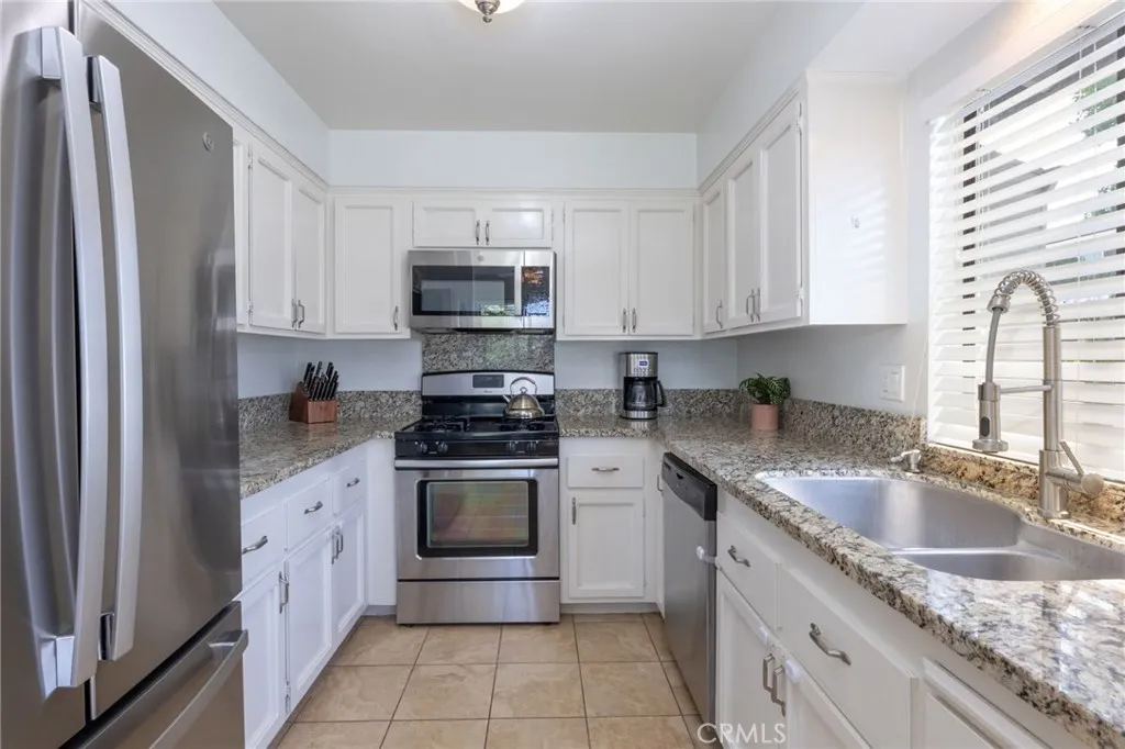 Large Kitchen with Granite Countertops, Stainless Steel Appliances, and window over sink.