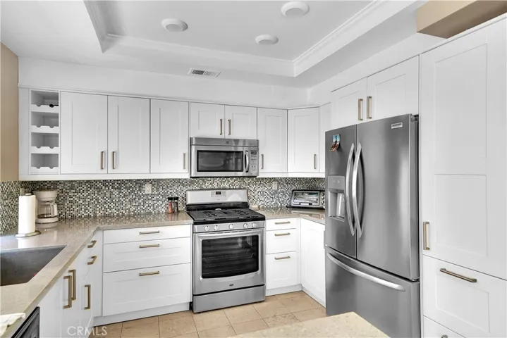 Stainless steel appliances and quartz counters.