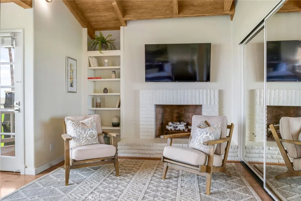 Gas fireplace in primary bedroom with seating area
