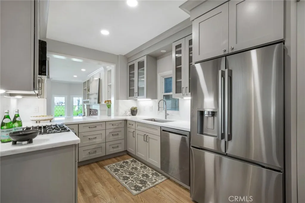 Newly remodeled kitchen with stainless steel appliances, overlooking the living room and ocean views