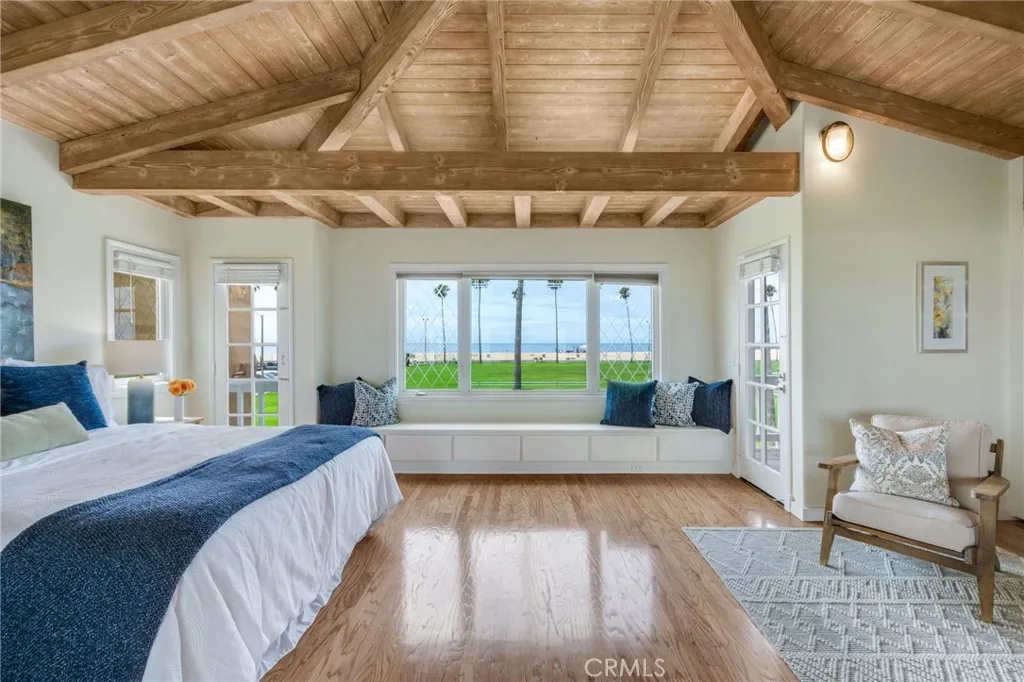 Large primary bedroom suite with endless ocean and beach views