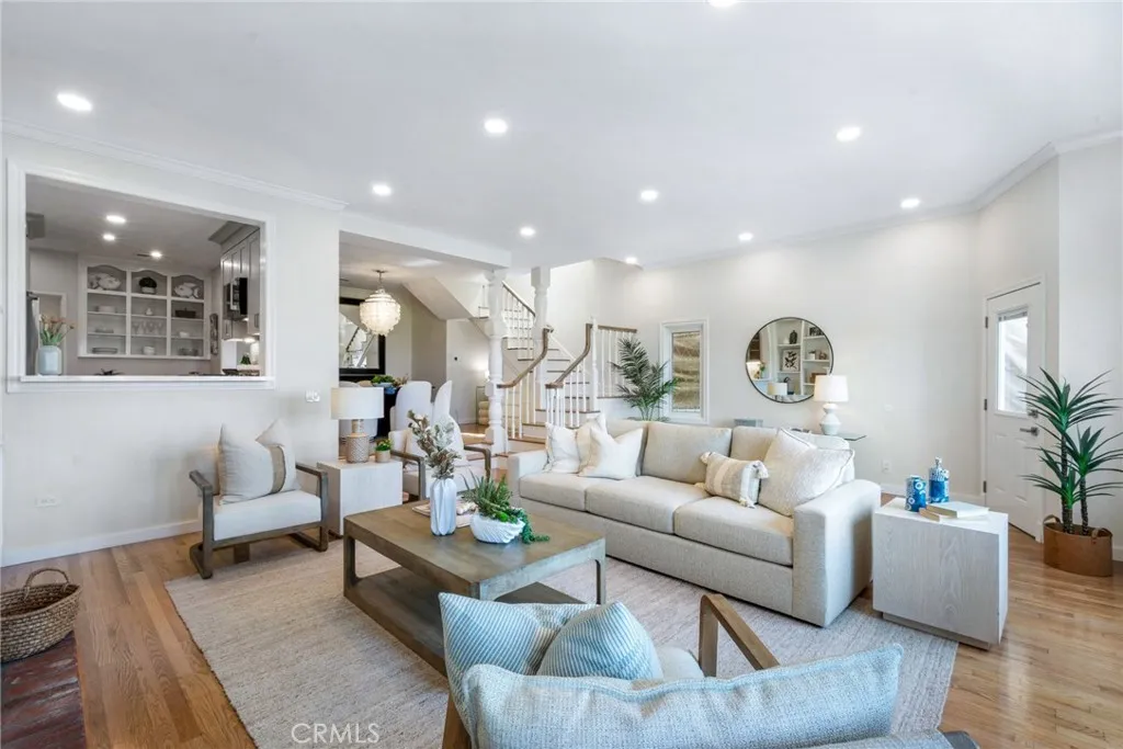 Spacious living room with high ceilings, open to kitchen and dining room