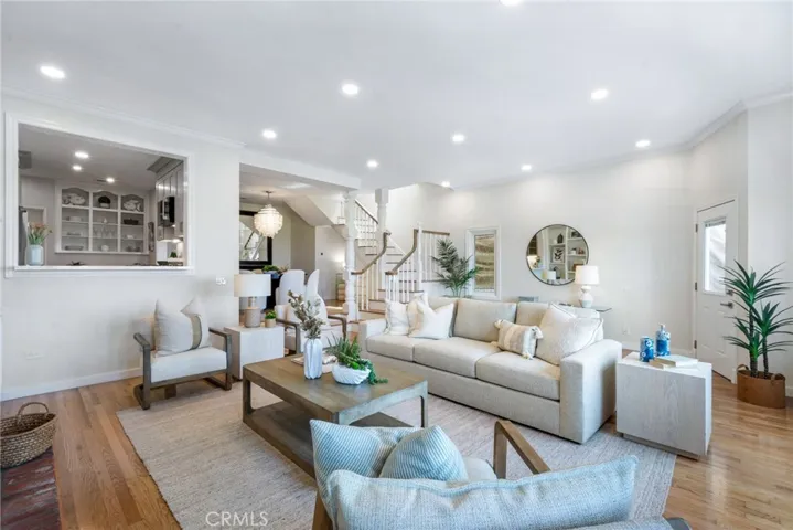 Spacious living room with high ceilings, open to kitchen and dining room