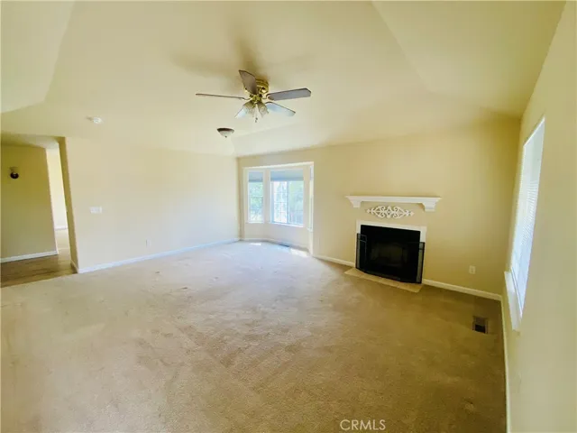 Living area has fireplace and vaulted ceiling.