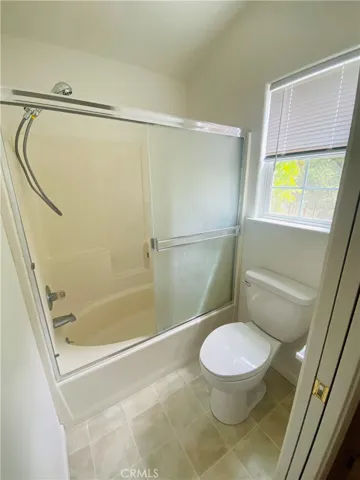 Primary bathroom shower over tub.