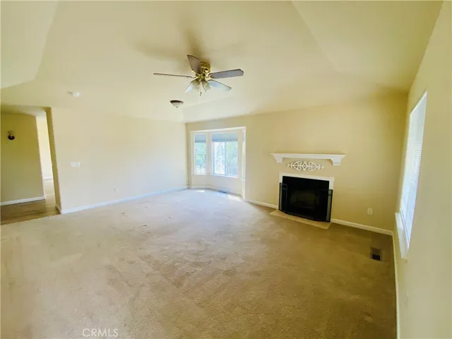 Living area has fireplace and vaulted ceiling.