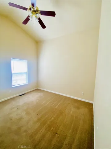 Primary bedroom has vaulted ceilings.
