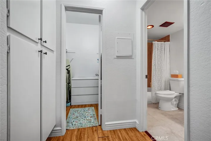 View of walk in closet and bathroom