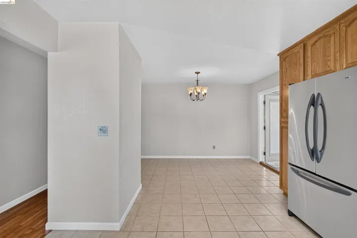 Open-concept interior featuring tile flooring and vaulted ceilings