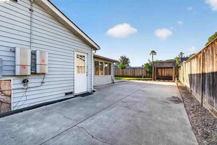 Spacious concrete patio extending from the property's siding exterior
