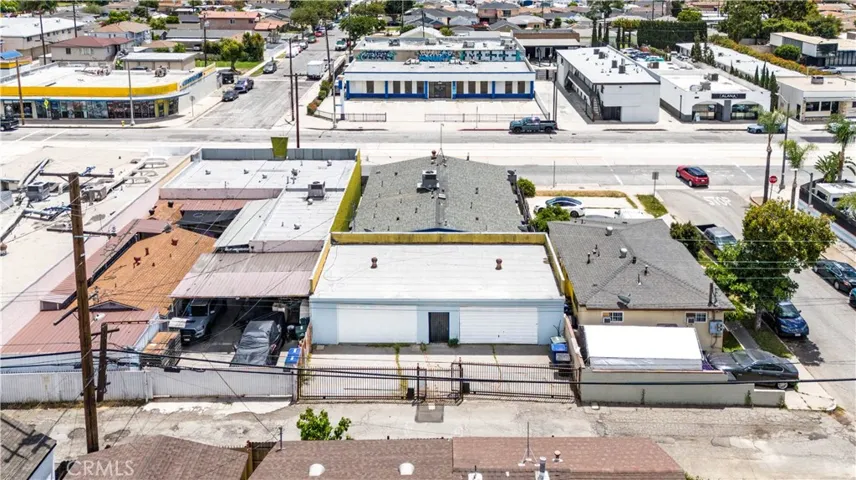 13175 and 13177 Paramount Blvd photo of the alley and the wrought iron gates to the separate garages.